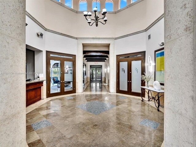 4960 SW 158th Ave, Miramar, FL 33027 - foyer featuring french doors, a towering ceiling, plenty of natural light, and a chandelier