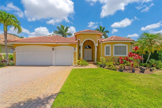 18951 SW 30th St, Miramar, FL 33029 - mediterranean / spanish-style home with an attached garage, a front lawn, decorative driveway, stucco siding, and a tiled roof