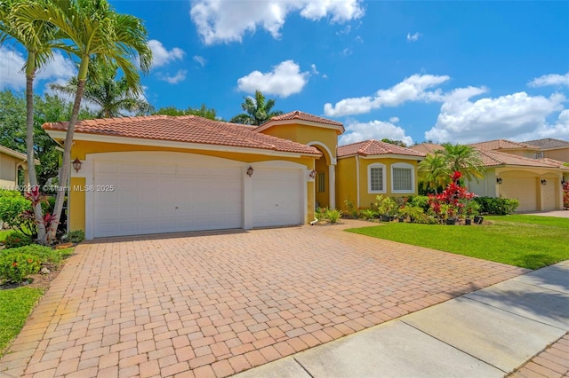 18951 SW 30th St, Miramar, FL 33029 - mediterranean / spanish-style house with a garage, decorative driveway, stucco siding, a front yard, and a tile roof