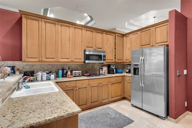 18951 SW 30th St, Miramar, FL 33029 - kitchen featuring appliances with stainless steel finishes, a sink, decorative backsplash, and brown cabinets
