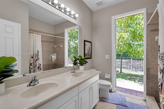 18951 SW 30th St, Miramar, FL 33029 - bathroom featuring tiled shower, toilet, and double vanity