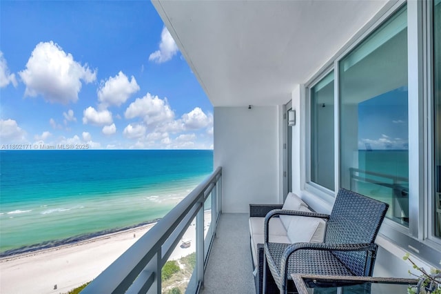 balcony featuring view of water and beach