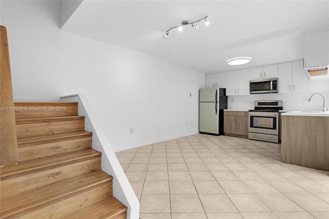 4718 SW 67th Ave Unit B6, Miami, FL 33155 - kitchen with appliances with stainless steel finishes, light countertops, a sink, and white cabinets