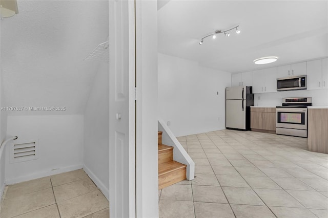 4718 SW 67th Ave Unit B6, Miami, FL 33155 - kitchen featuring appliances with stainless steel finishes, light tile patterned floors, light countertops, and white cabinets