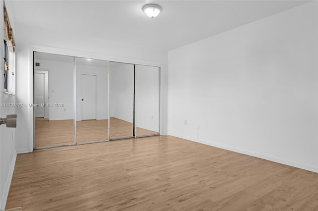 4718 SW 67th Ave Unit B6, Miami, FL 33155 - unfurnished bedroom featuring wood finished floors, baseboards, and a closet