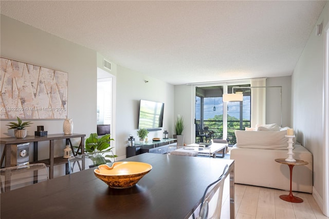 900 Saint Charles Pl Unit 621, Pembroke Pines, FL 33026 - dining space featuring a wall of windows and light wood finished floors