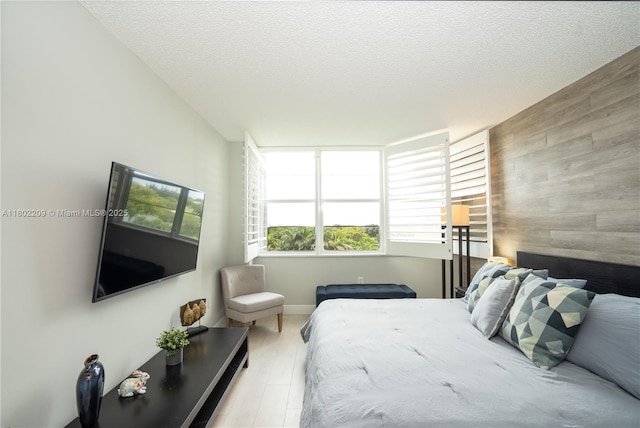 900 Saint Charles Pl Unit 621, Pembroke Pines, FL 33026 - bedroom featuring multiple windows, an accent wall, wooden walls, and a textured ceiling