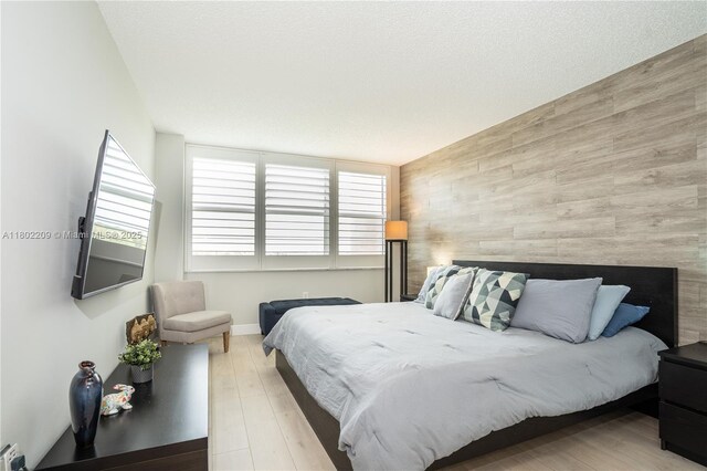 900 Saint Charles Pl Unit 621, Pembroke Pines, FL 33026 - bedroom featuring an accent wall, wood finished floors, and wooden walls