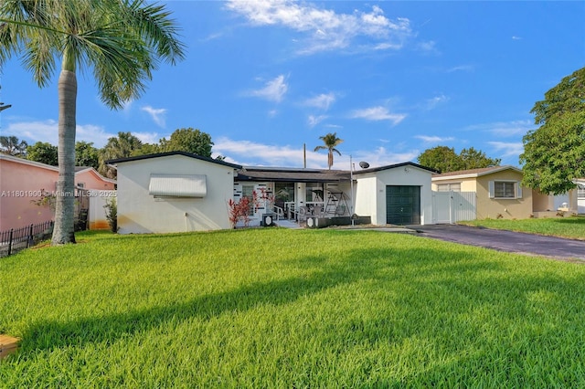 7908 Coral Blvd, Miramar, FL 33023 - ranch-style house with an attached garage, asphalt driveway, solar panels, and stucco siding