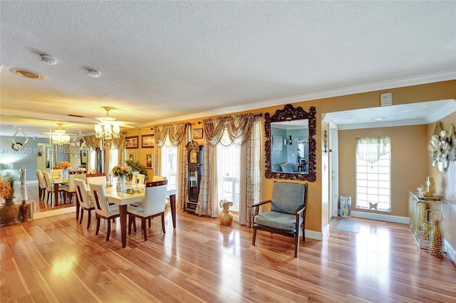7908 Coral Blvd, Miramar, FL 33023 - dining space with a textured ceiling, ornamental molding, wood finished floors, a chandelier, and baseboards