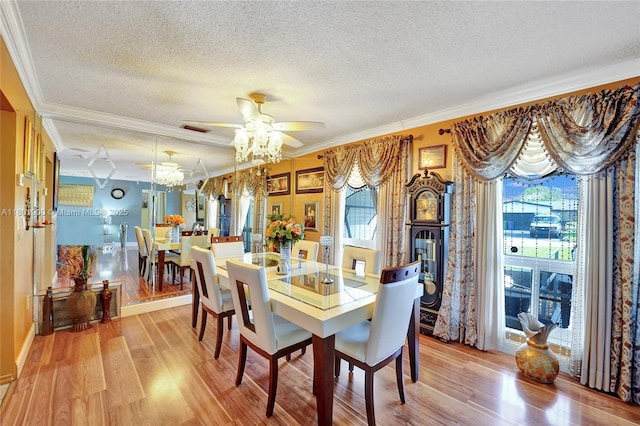 7908 Coral Blvd, Miramar, FL 33023 - dining room featuring a textured ceiling, ornamental molding, a ceiling fan, light wood finished floors, and healthy amount of natural light