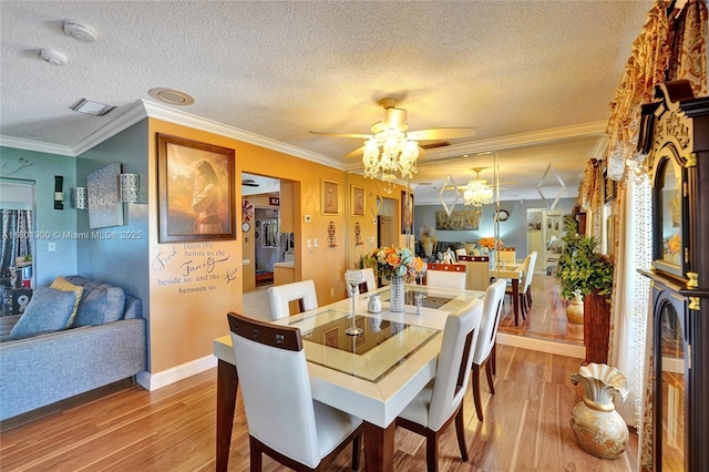 7908 Coral Blvd, Miramar, FL 33023 - dining room with wood finished floors, ceiling fan, a textured ceiling, crown molding, and baseboards