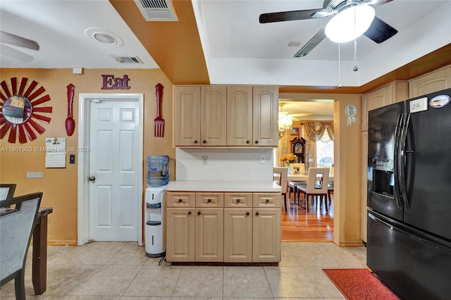 7908 Coral Blvd, Miramar, FL 33023 - kitchen with black refrigerator with ice dispenser, ceiling fan, light tile patterned floors, light countertops, and light brown cabinetry