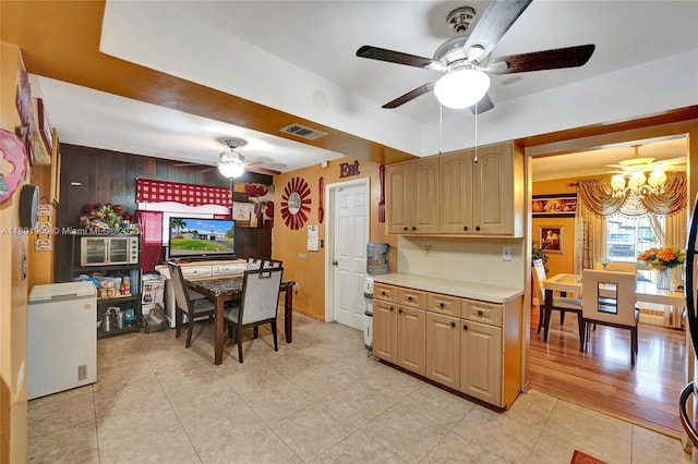 7908 Coral Blvd, Miramar, FL 33023 - kitchen featuring ceiling fan, light tile patterned floors, light countertops, white fridge, and a chandelier