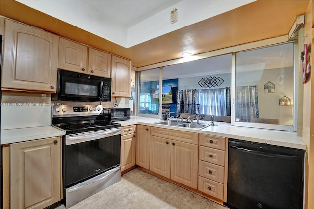 7908 Coral Blvd, Miramar, FL 33023 - kitchen with black appliances, light brown cabinets, light countertops, light tile patterned floors, and a sink