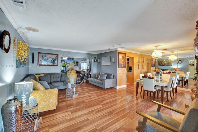 7908 Coral Blvd, Miramar, FL 33023 - living room featuring a textured ceiling, crown molding, light wood-type flooring, a chandelier, and baseboards