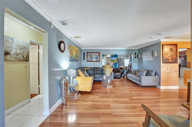 7908 Coral Blvd, Miramar, FL 33023 - living room featuring ornamental molding, light wood-type flooring, a textured ceiling, and baseboards