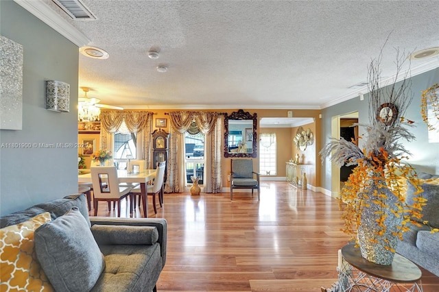 7908 Coral Blvd, Miramar, FL 33023 - living room featuring a textured ceiling, ornamental molding, wood finished floors, and baseboards