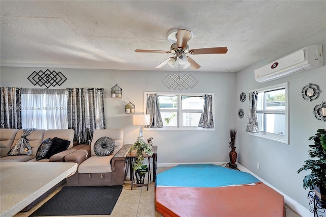 7908 Coral Blvd, Miramar, FL 33023 - living area featuring a wall unit AC, ceiling fan, baseboards, light tile patterned flooring, and a textured ceiling