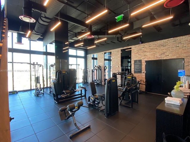 398 NE 5th St Unit 2910, Miami, FL 33132 - exercise room with a towering ceiling and brick wall