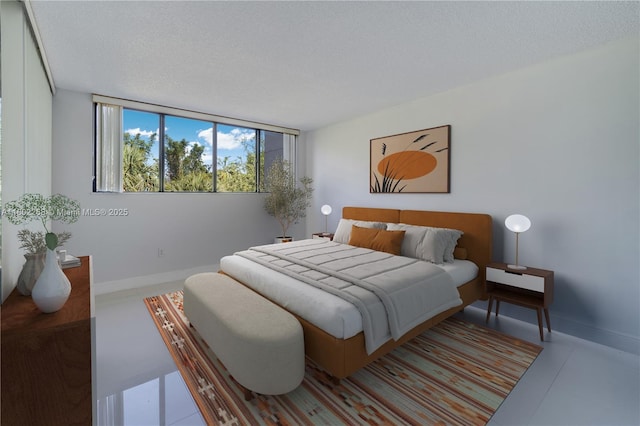 bedroom with baseboards and a textured ceiling