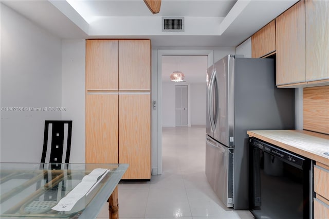 kitchen featuring dishwasher, a tray ceiling, and light tile patterned floors