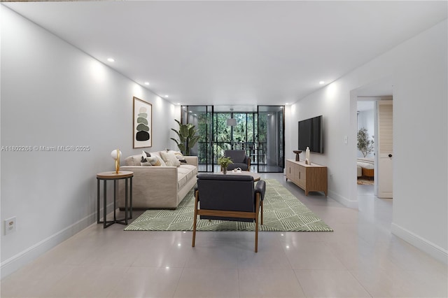 tiled living area with baseboards, floor to ceiling windows, and recessed lighting