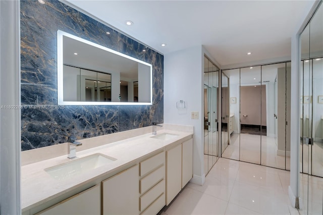 bathroom featuring double vanity, tile patterned floors, decorative backsplash, french doors, and recessed lighting