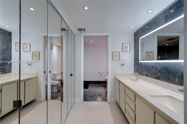 bathroom with toilet, double vanity, recessed lighting, baseboards, and tile patterned flooring
