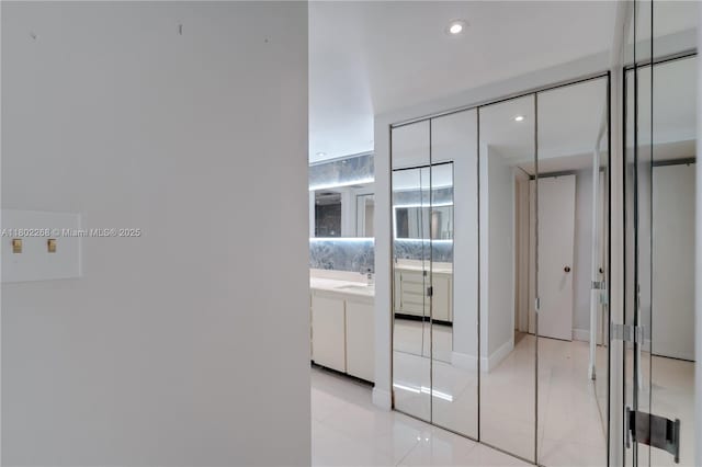 hallway featuring recessed lighting and light tile patterned flooring