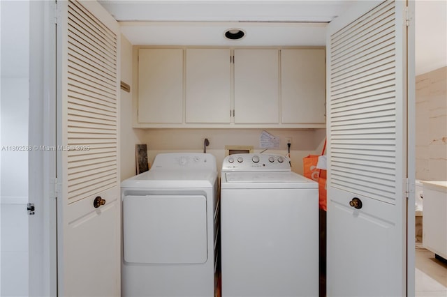 laundry room featuring washer and clothes dryer and cabinet space