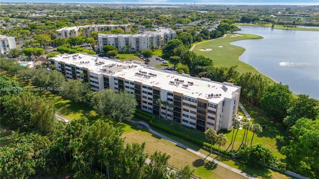 drone / aerial view of apartment complex, a large body of water, and a golf club