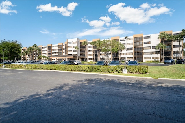 view of apartment building / complex featuring uncovered parking