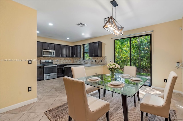 6973 Broadland Way, Coconut Creek, FL 33073 - dining room featuring baseboards, light tile patterned flooring, and recessed lighting