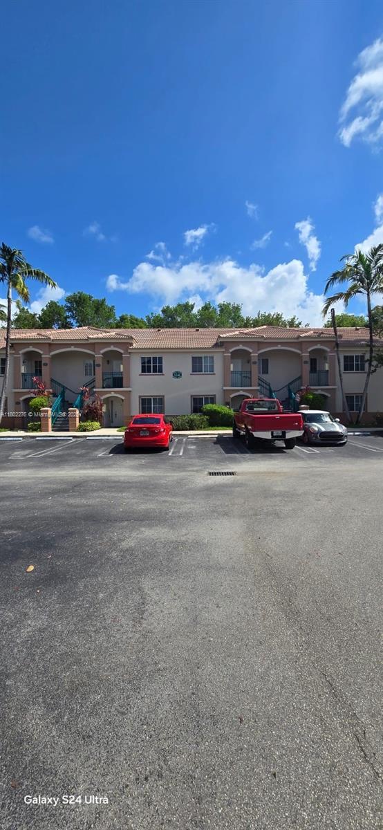 1241 SE 29th St Unit 203-27, Homestead, FL 33035 - multi unit property featuring a tile roof, stucco siding, and uncovered parking