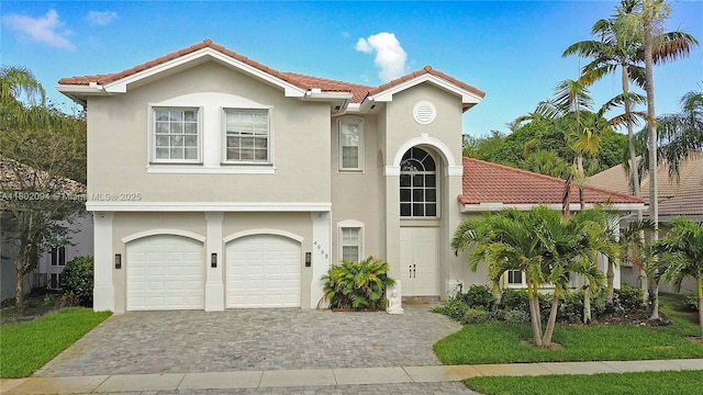 4968 SW 183rd Ave, Miramar, FL 33029 - mediterranean / spanish-style house featuring a tiled roof, decorative driveway, a garage, and stucco siding