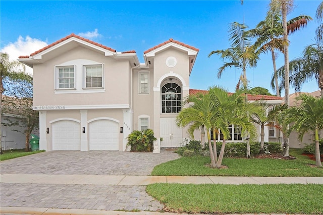 4968 SW 183rd Ave, Miramar, FL 33029 - mediterranean / spanish-style house with decorative driveway, stucco siding, a tiled roof, and a garage