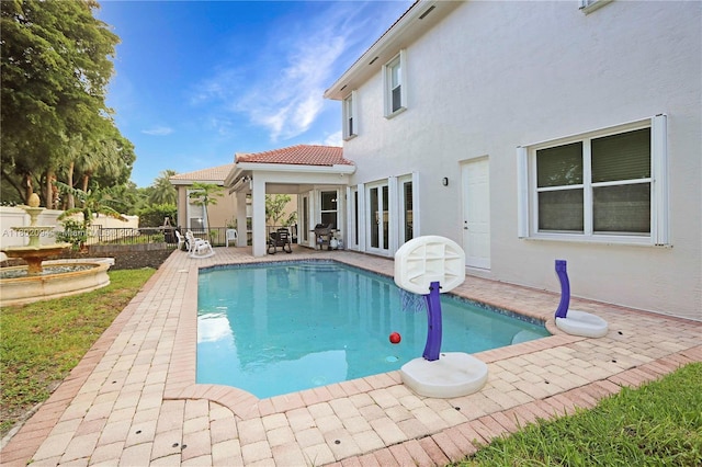 4968 SW 183rd Ave, Miramar, FL 33029 - view of swimming pool featuring a patio, fence, and french doors