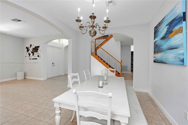 4968 SW 183rd Ave, Miramar, FL 33029 - dining room featuring arched walkways, light tile patterned floors, stairs, and a chandelier