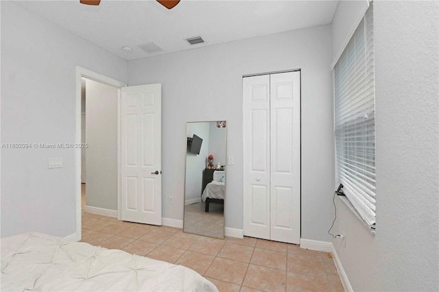 4968 SW 183rd Ave, Miramar, FL 33029 - bedroom featuring light tile patterned floors, a closet, baseboards, and a ceiling fan