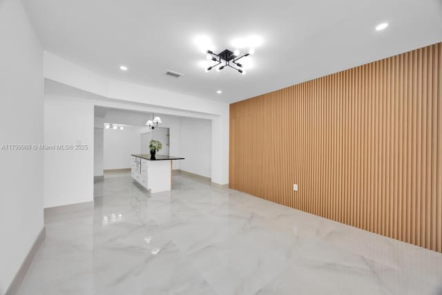 5410 SW 2nd St, Miami, FL 33134 - spare room with light marble finish flooring, a chandelier, recessed lighting, an accent wall, and baseboards