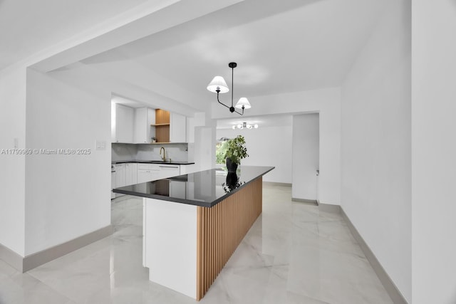 5410 SW 2nd St, Miami, FL 33134 - kitchen with a sink, white cabinetry, dark countertops, and baseboards