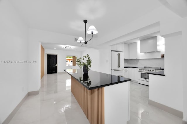 5410 SW 2nd St, Miami, FL 33134 - kitchen with high quality appliances, dark countertops, wall chimney range hood, white cabinets, and decorative backsplash