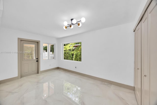 5410 SW 2nd St, Miami, FL 33134 - entryway featuring a chandelier, light marble finish floors, and baseboards