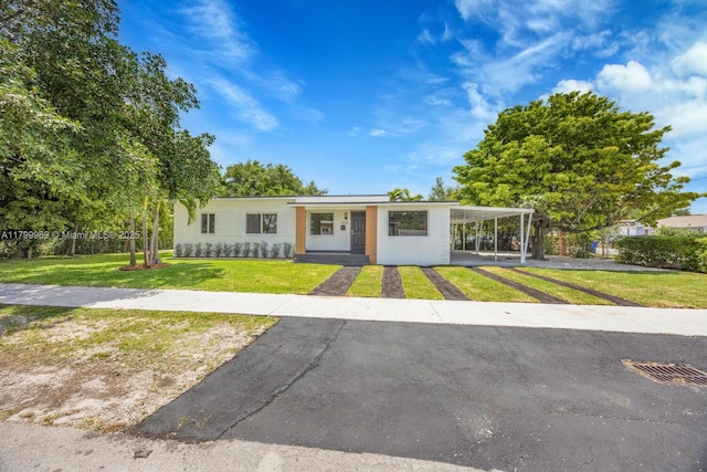 5410 SW 2nd St, Miami, FL 33134 - view of front of home featuring driveway, a front lawn, a carport, and stucco siding