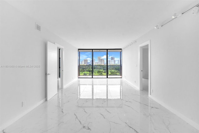 20335 W Country Club Dr Unit 1108, Aventura, FL 33180 - unfurnished room featuring expansive windows, baseboards, light marble finish flooring, and a city view
