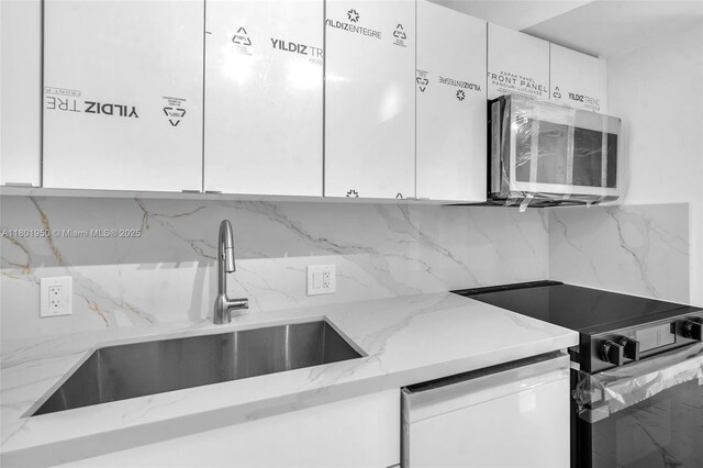 20335 W Country Club Dr Unit 1108, Aventura, FL 33180 - kitchen with black range with electric stovetop, white dishwasher, white cabinets, and stainless steel microwave