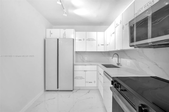 20335 W Country Club Dr Unit 1108, Aventura, FL 33180 - kitchen with stainless steel appliances, a sink, white cabinets, and light stone counters