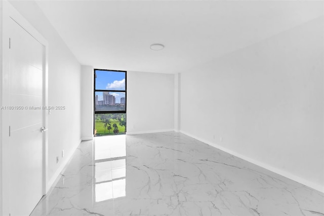 20335 W Country Club Dr Unit 1108, Aventura, FL 33180 - spare room featuring marble tiled floors, a wall of windows, and baseboards