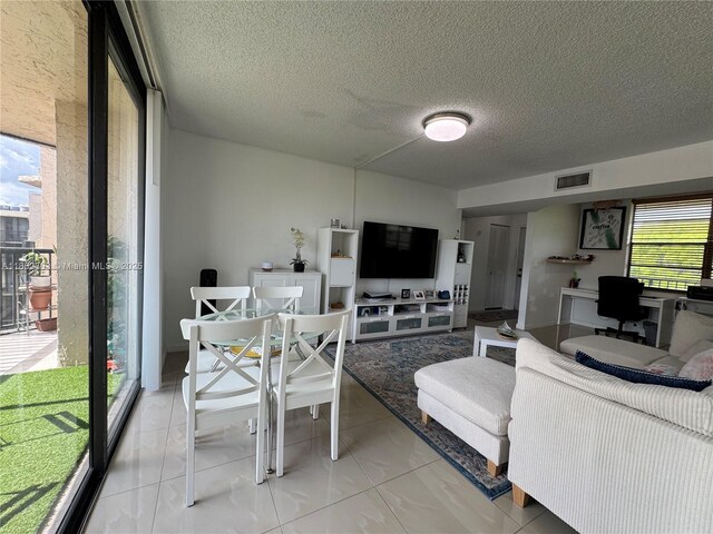 3550 Blue Lake Dr Unit 501, Pompano Beach, FL 33064 - living room featuring a textured ceiling
